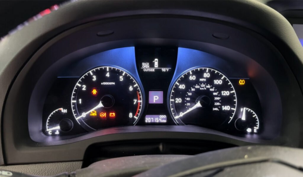 Car dashboard showing TPMS warning light – TPMS sensor replacement cost factor