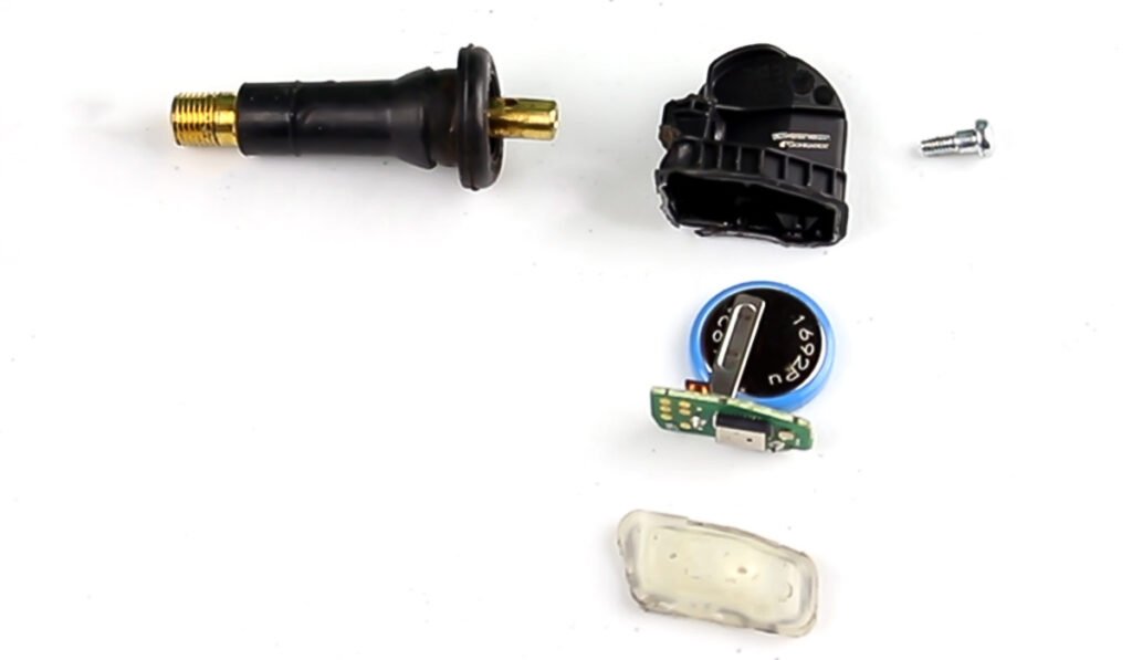 Internal view of a TPMS sensor showing its battery and chip components.