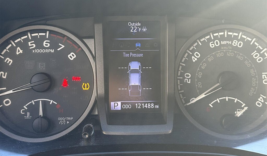 TPMS warning light indicating tire pressure issues. Turning off TPMS can increase the likelihood of tire blowouts