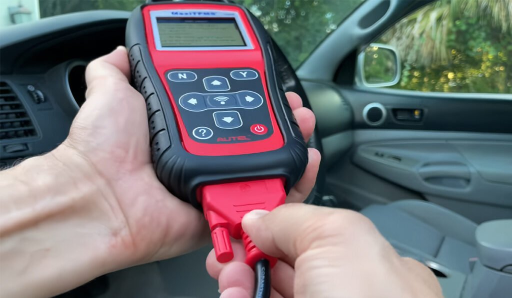 Professional mechanic using TPMS programmer – how to program TPMS sensors in workshop