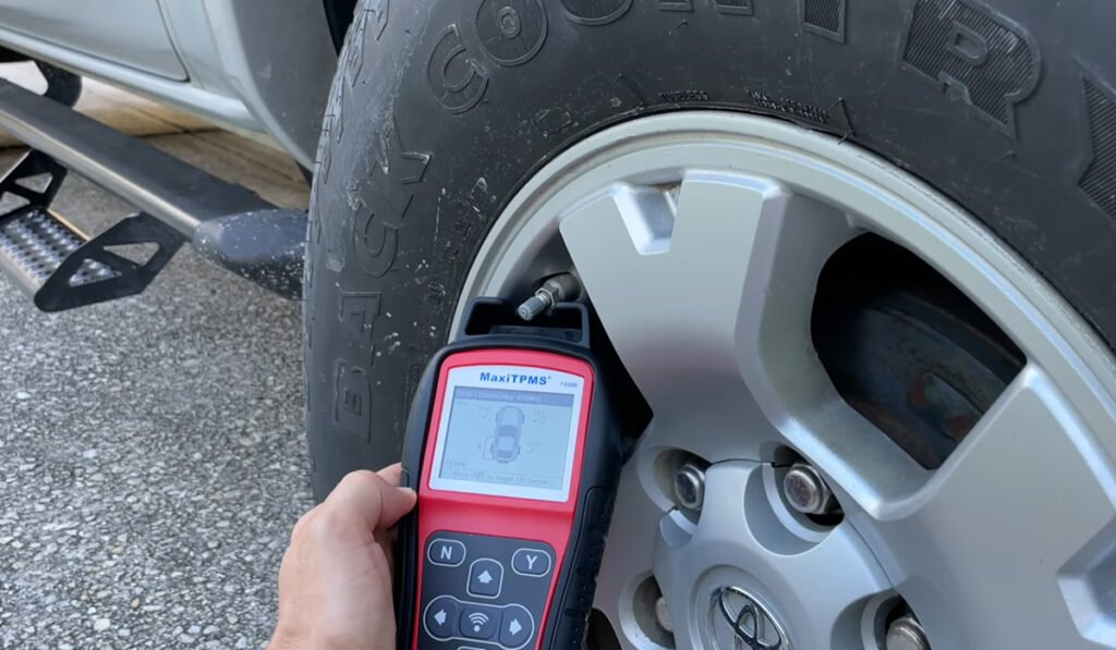 Tire pressure matching tool connecting to a car’s TPMS system to configure or deactivate the monitoring system.