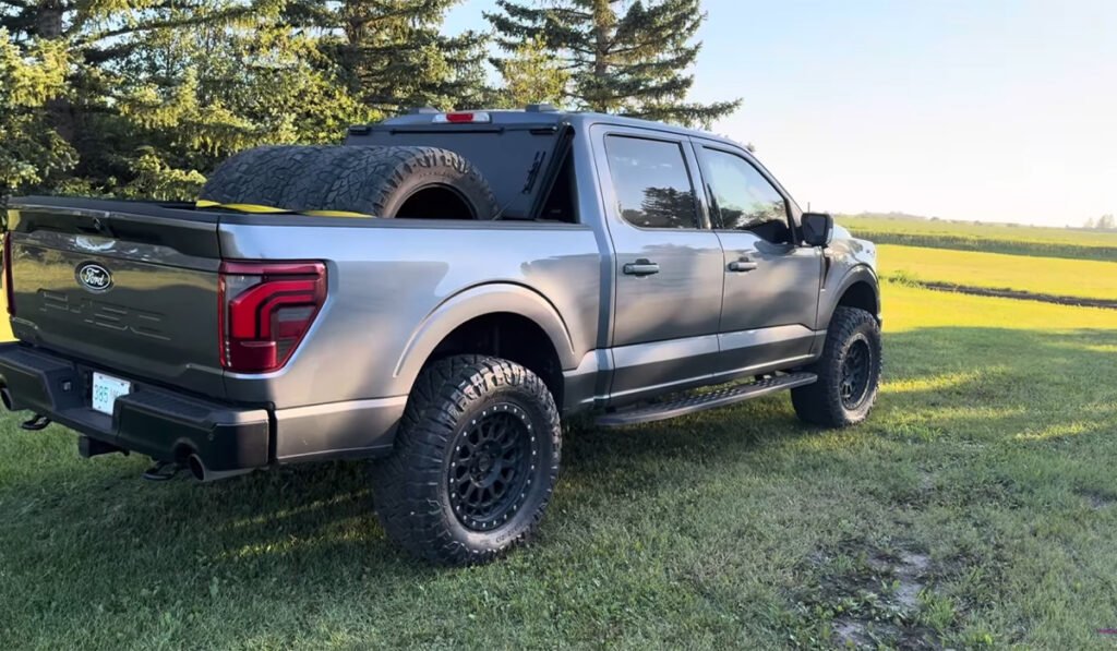 Car on a grassy lawn with highlighted front and rear tires to illustrate TPMS sensor front rear position differentiation.